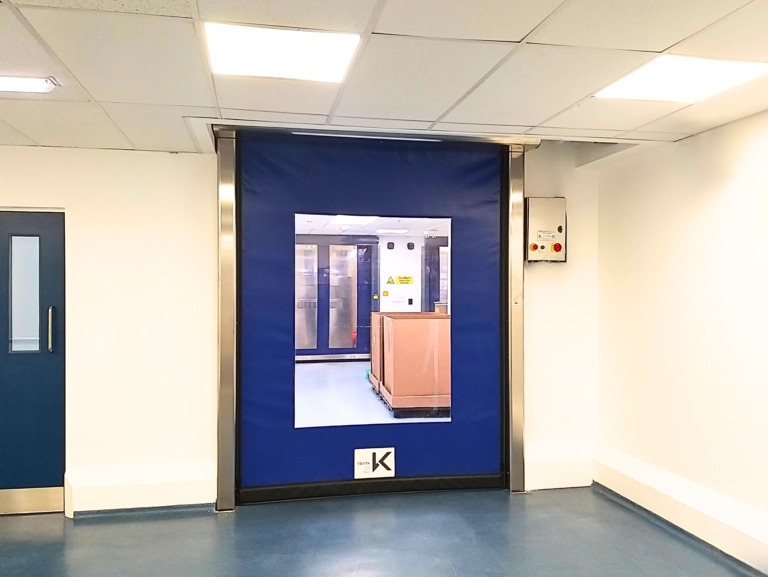 Rapidor Pharma blue self-repairing high speed door with 1 large vision windows installed in a pharmaceutical factory.