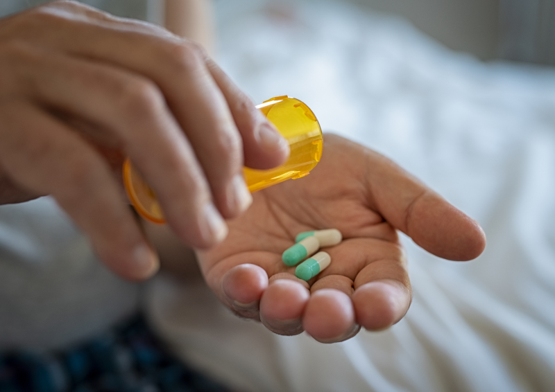 Medicine being poured into a hand