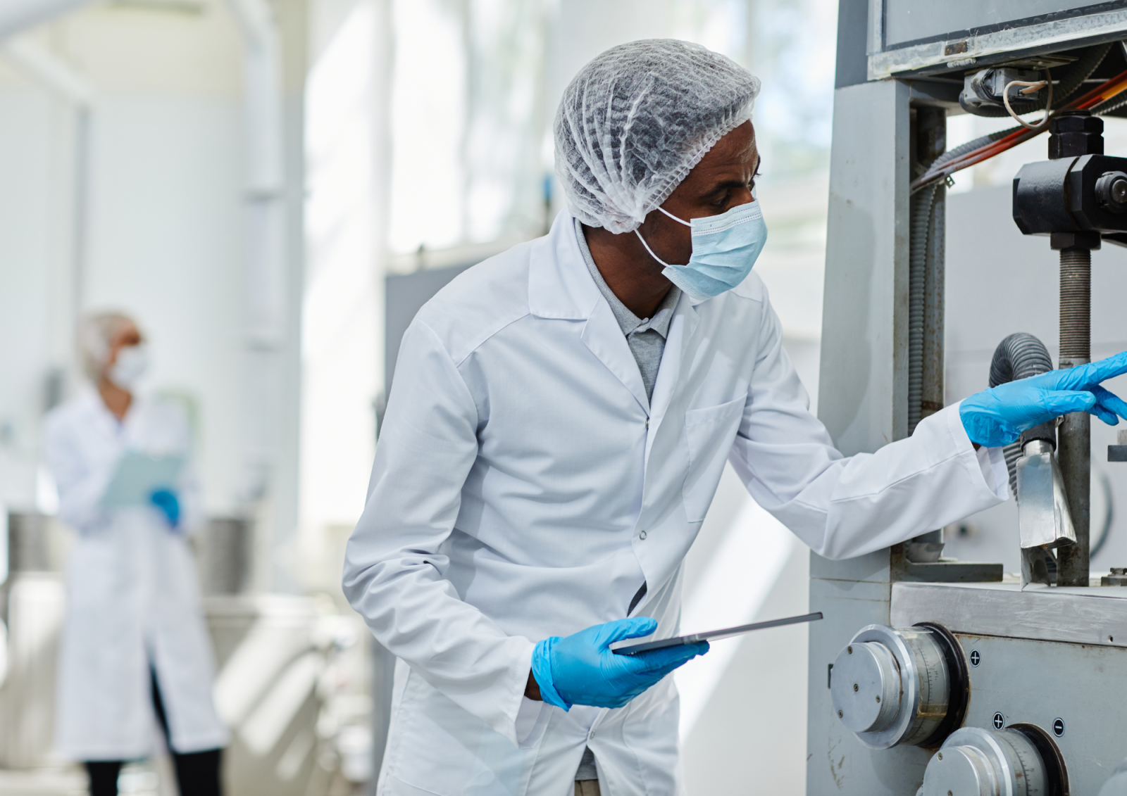 Scientist checking manufacturing equipment